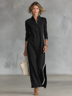 Three-quarter view of a woman wearing the black striped maxi dress paired with strappy sandals