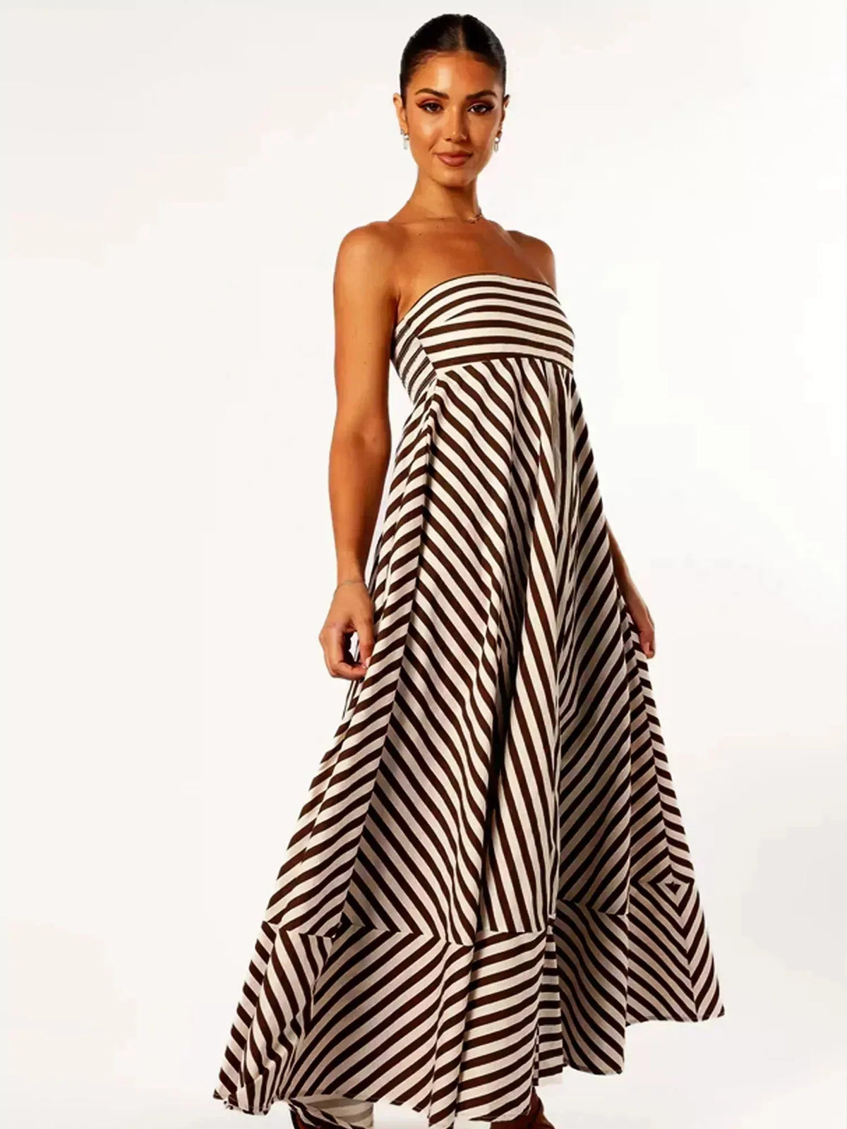 Side profile view of the strapless striped maxi dress showing the asymmetric flared hemline