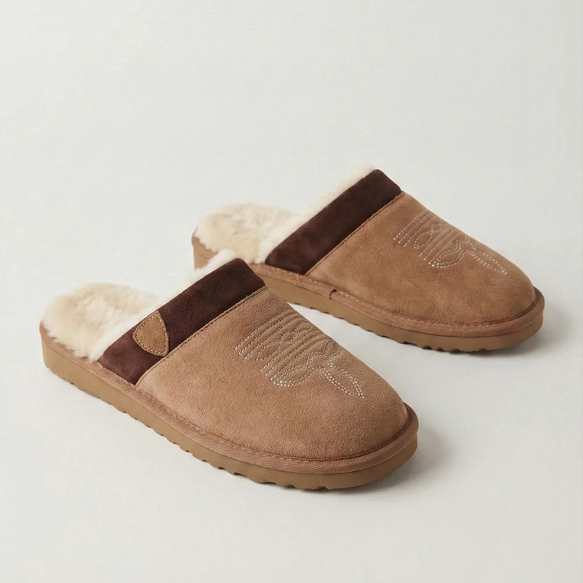 Pair of chestnut suede cowboy slippers shown together on a plain background