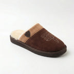 Three-quarter angle of dark brown suede slipper with tan cuff and stitched western design