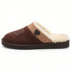 Side profile of a dark brown suede slipper showing the tan cuff and cream fur lining