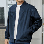 Close-up of a navy bomber jacket worn open over a white t-shirt, highlighting the smooth texture and zip detail