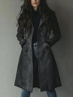 Charcoal grey suede-finish longline coat buttoned up, worn with a black jumper and denim jeans
