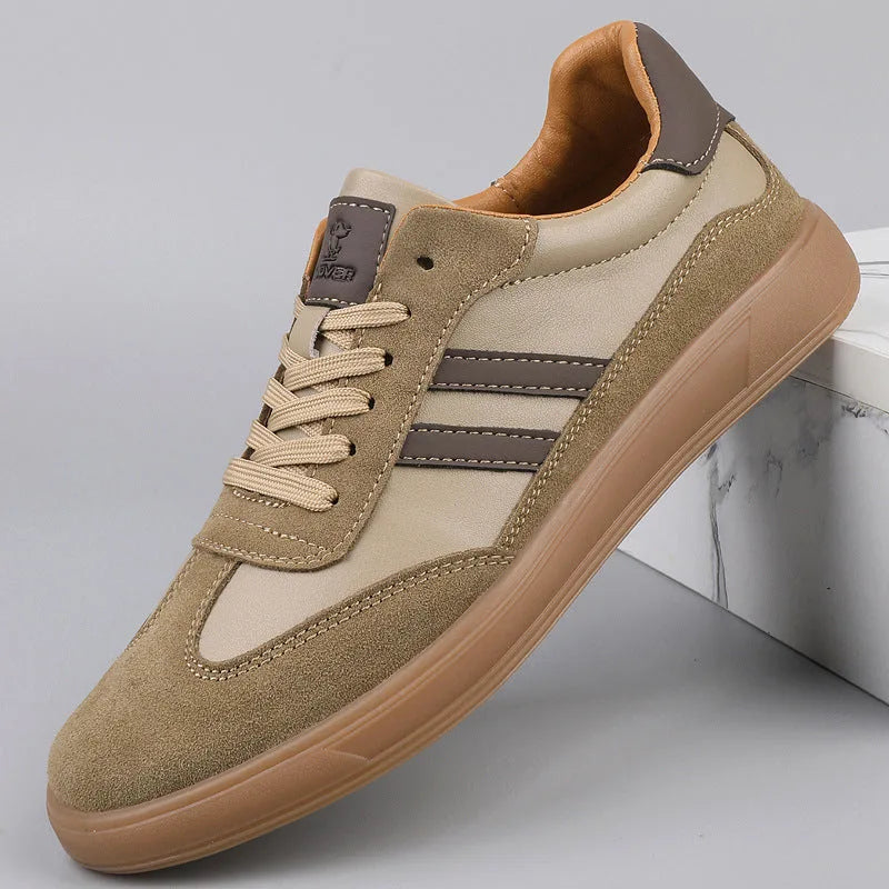 Side profile of khaki trainer with contrast dark stripes, lace-up front and gum rubber outsole