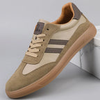 Side profile of khaki trainer with contrast dark stripes, lace-up front and gum rubber outsole