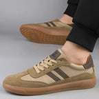 Pair of khaki trainers on foot, back view showing heel tab and textured gum sole tread
