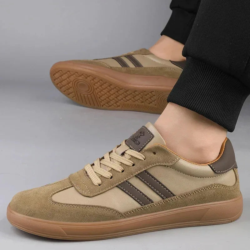 Pair of khaki trainers on foot, back view showing heel tab and textured gum sole tread