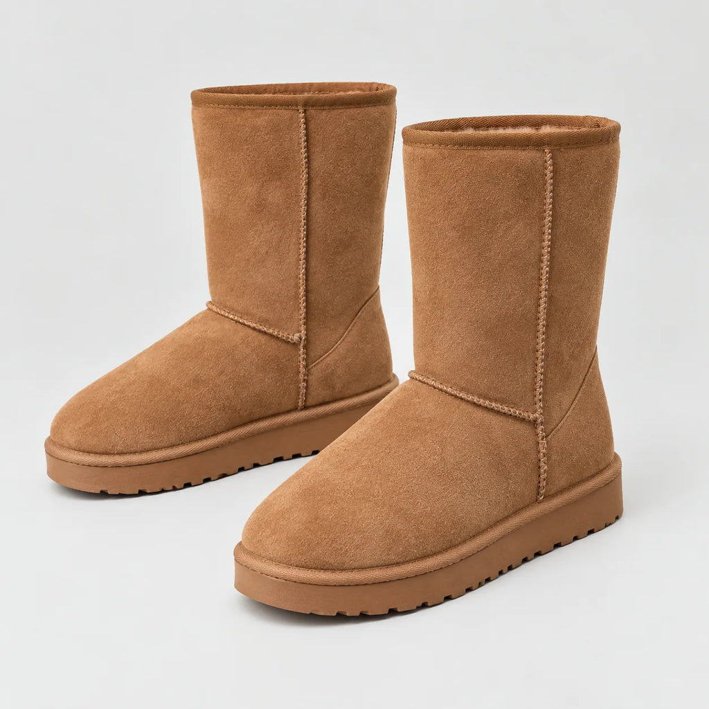 Pair of tan suede winter boots shown together, angled to show the rounded toe and stitched seams