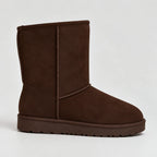 Side view of a dark brown suede mid-calf boot with vertical seam stitching and matching sole