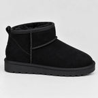 Side profile of a black suede mini ankle boot with matching stitched pull tab and chunky tread sole