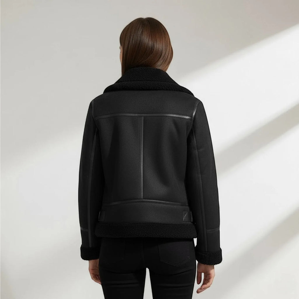 Back view of the black suede biker jacket showing the structured seaming and shearling cuffs