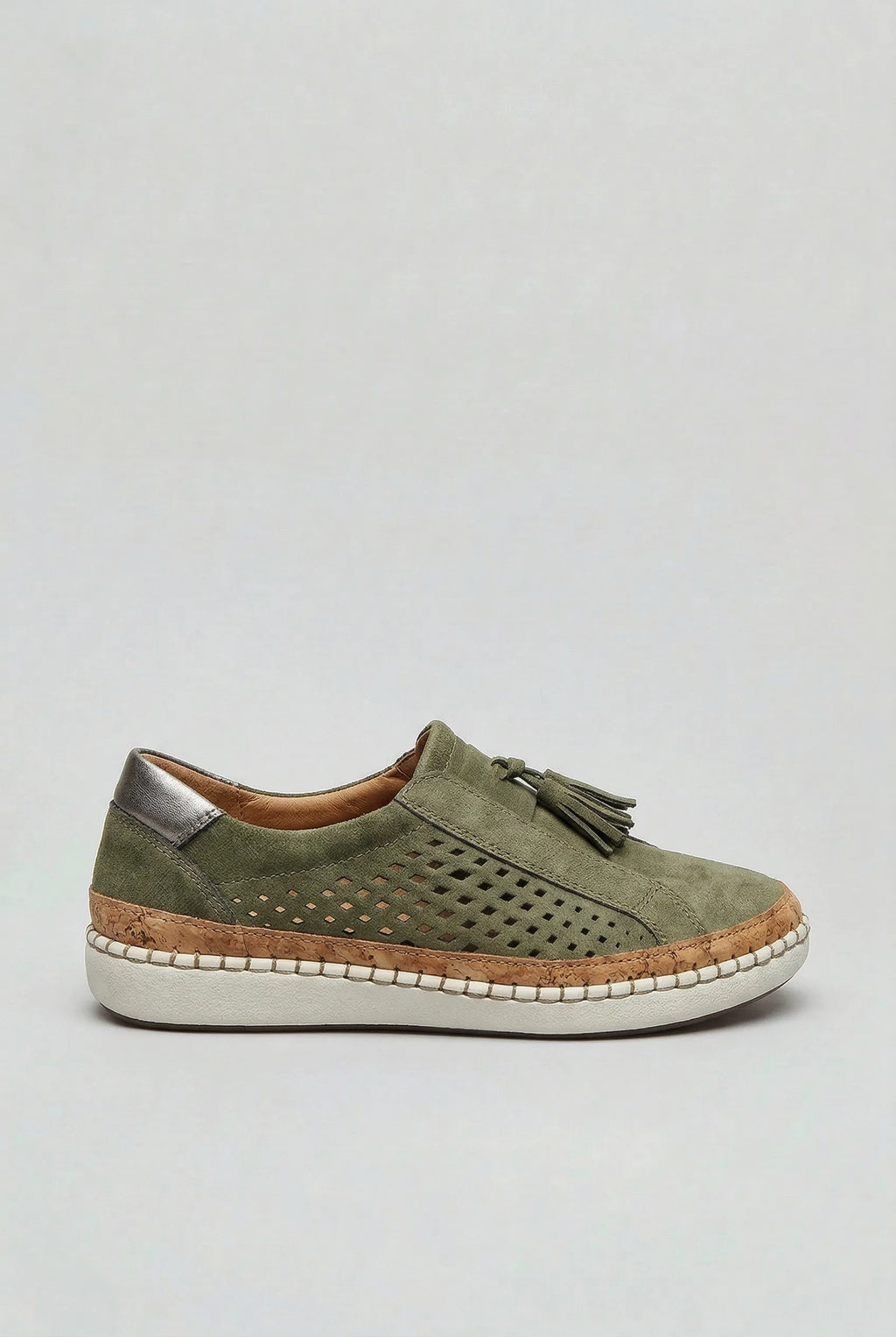 Side view of a green suede slip-on trainer with perforated cut-out detail, tassel trim and cork-wrapped platform sole