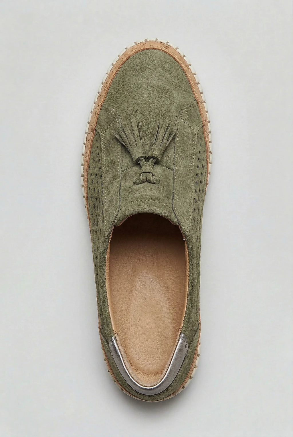 Top-down view of a green suede slip-on trainer showing the perforated diamond pattern and cork midsole edge