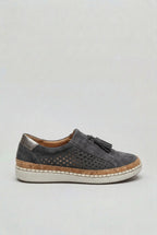 Full side profile of a slip-on trainer highlighting the metallic heel tab, suede tassel and cork-wrapped platform