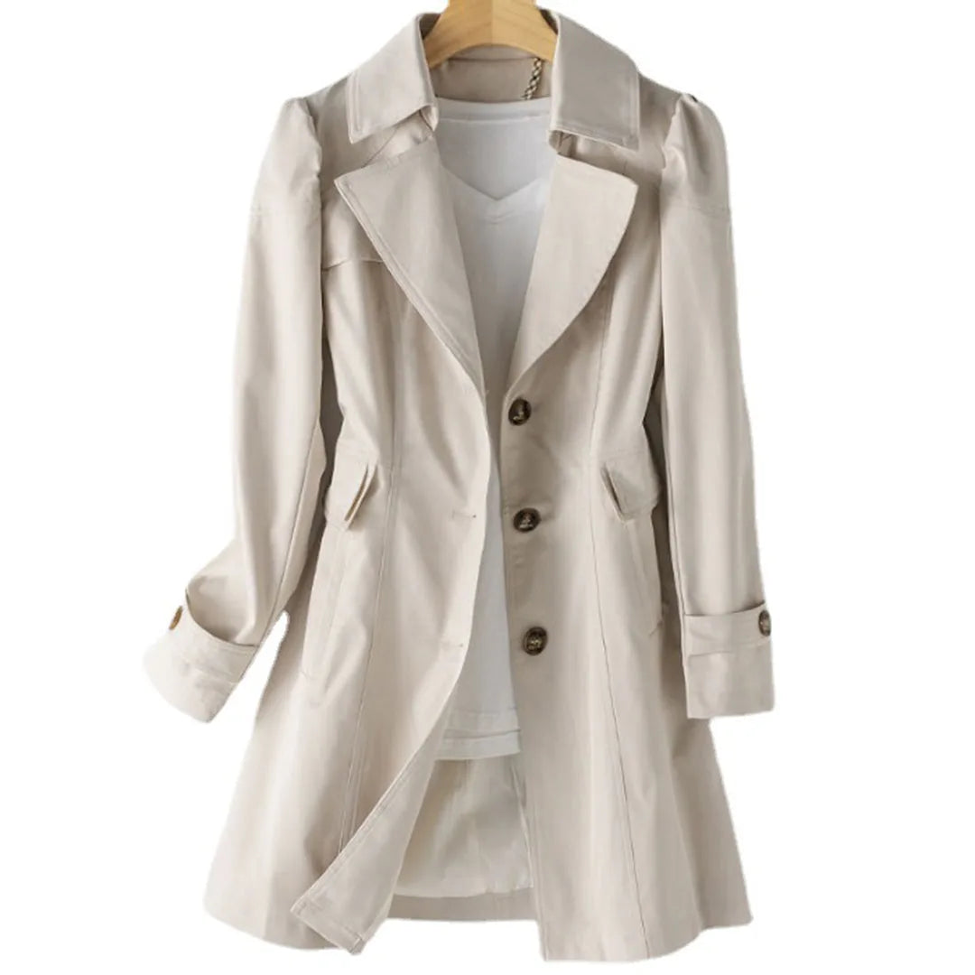 Beige trench coat displayed on a wooden hanger, showing the wide lapel collar and tortoiseshell button placket