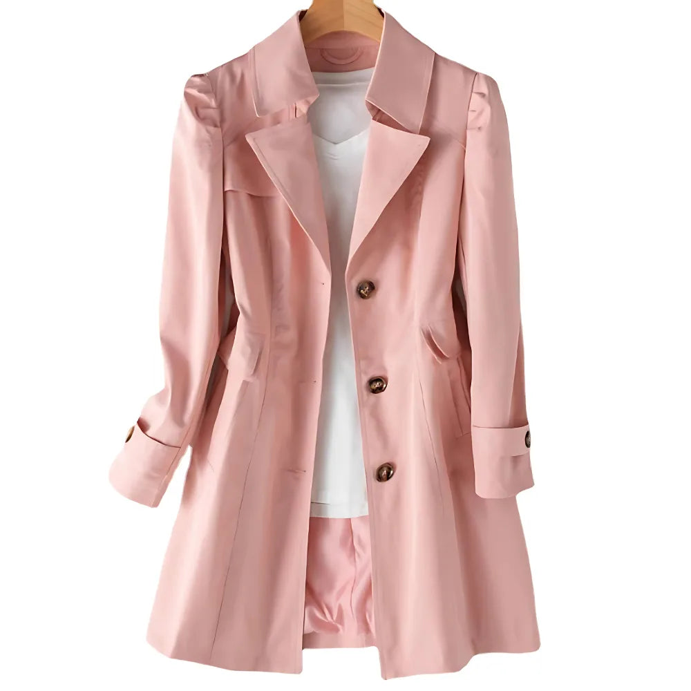 Pink tailored trench coat on hanger with classic collar and three-button closure, shown open over a white top