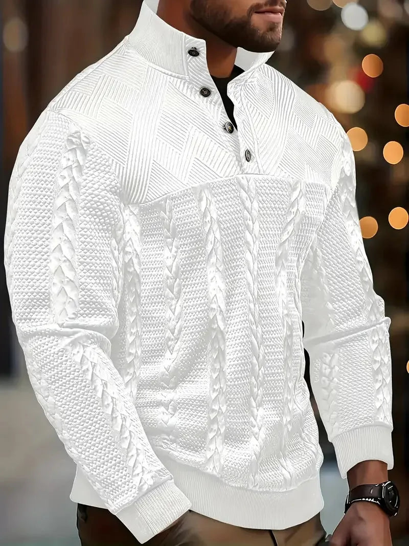 Side view of a man wearing a white cable-knit quarter-zip jumper with button stand collar, outdoors at night