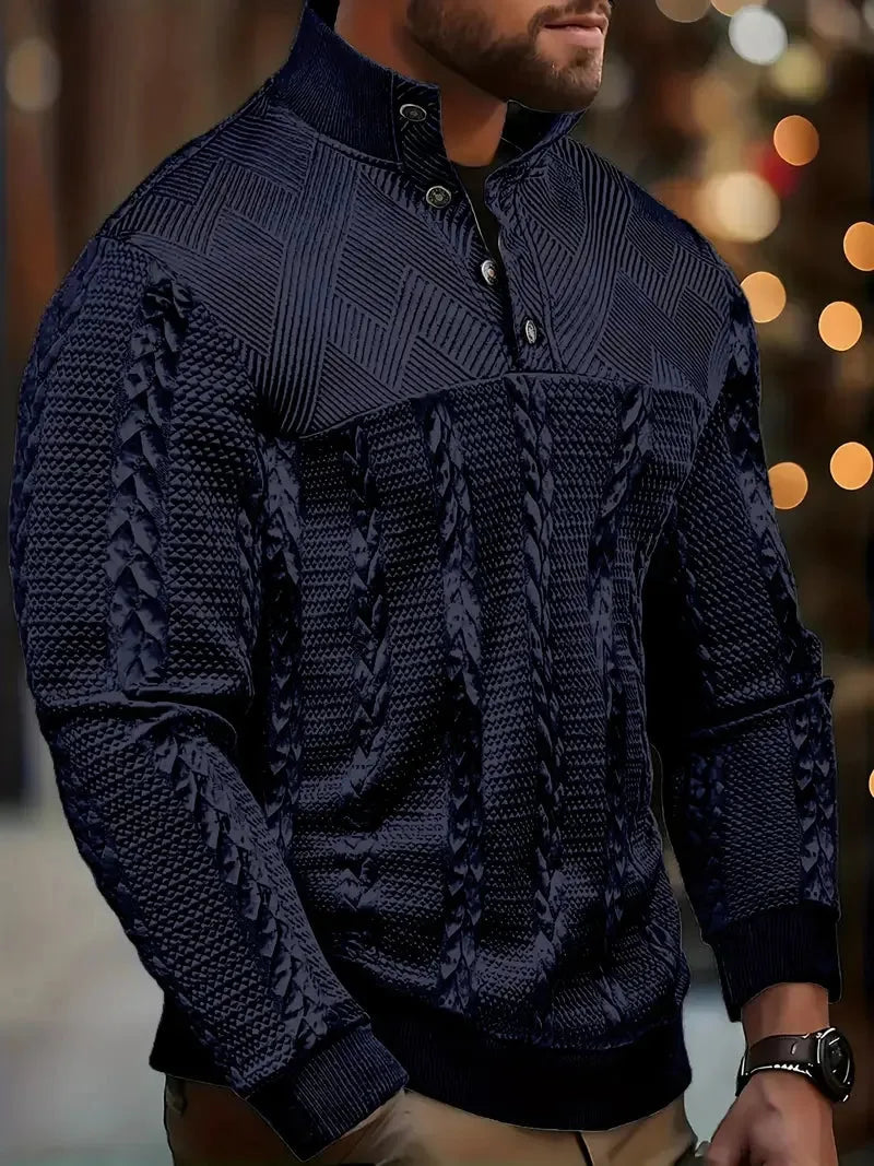 Three-quarter view of a man modelling the white jumper with hands in trouser pockets