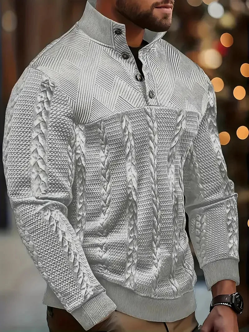 Detail view of the cable-knit sleeve and ribbed cuff on the white jumper