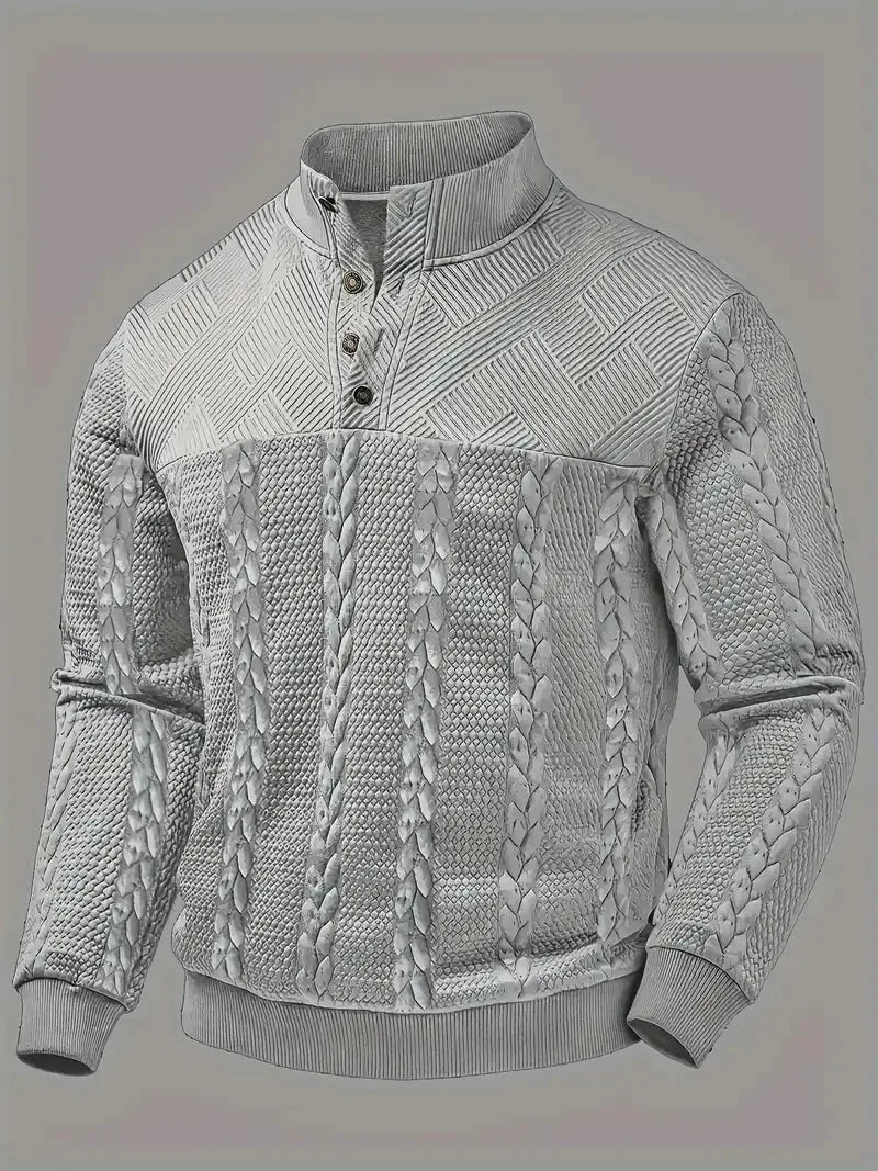 Front flat view of the jumper in grey, showing the full cable-knit pattern and ribbed hem