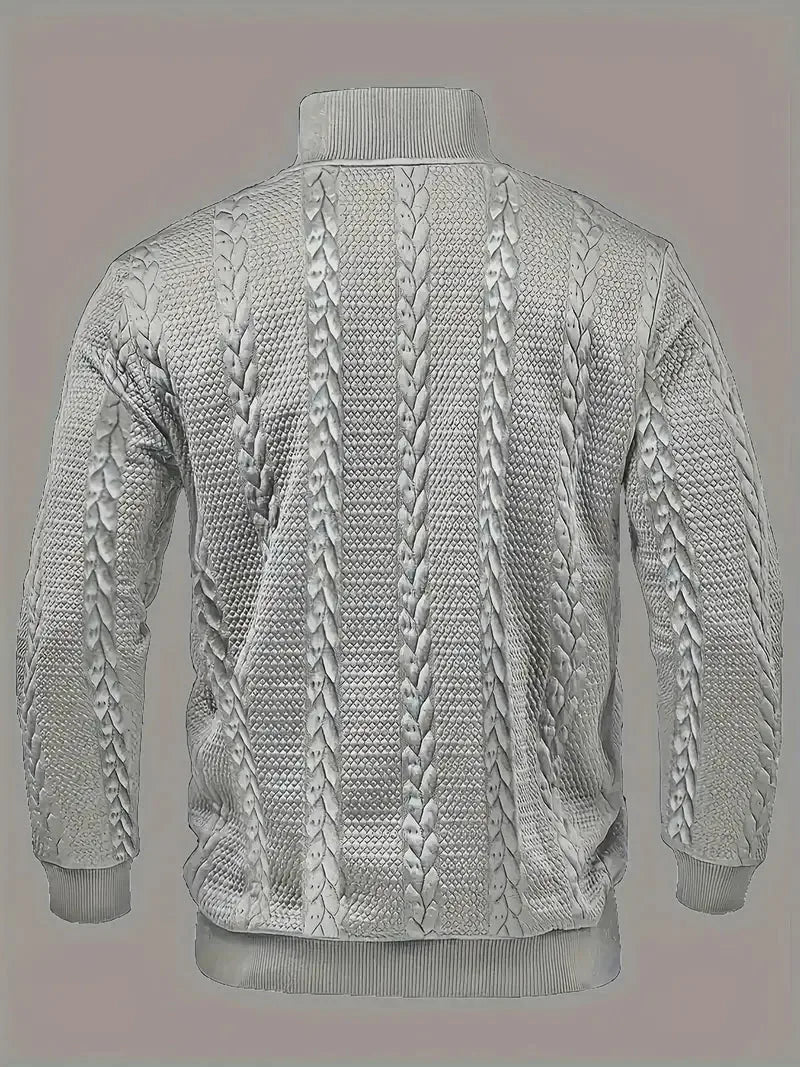 Back view of the grey jumper showing the continuous cable-knit pattern across the shoulders