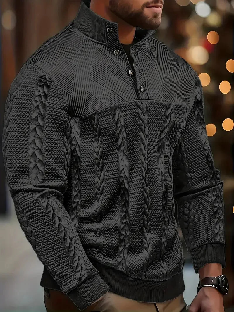 Close-up side view of a man wearing the jumper in black, showing the button collar and knit texture