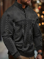 Close-up side view of a man wearing the jumper in black, showing the button collar and knit texture