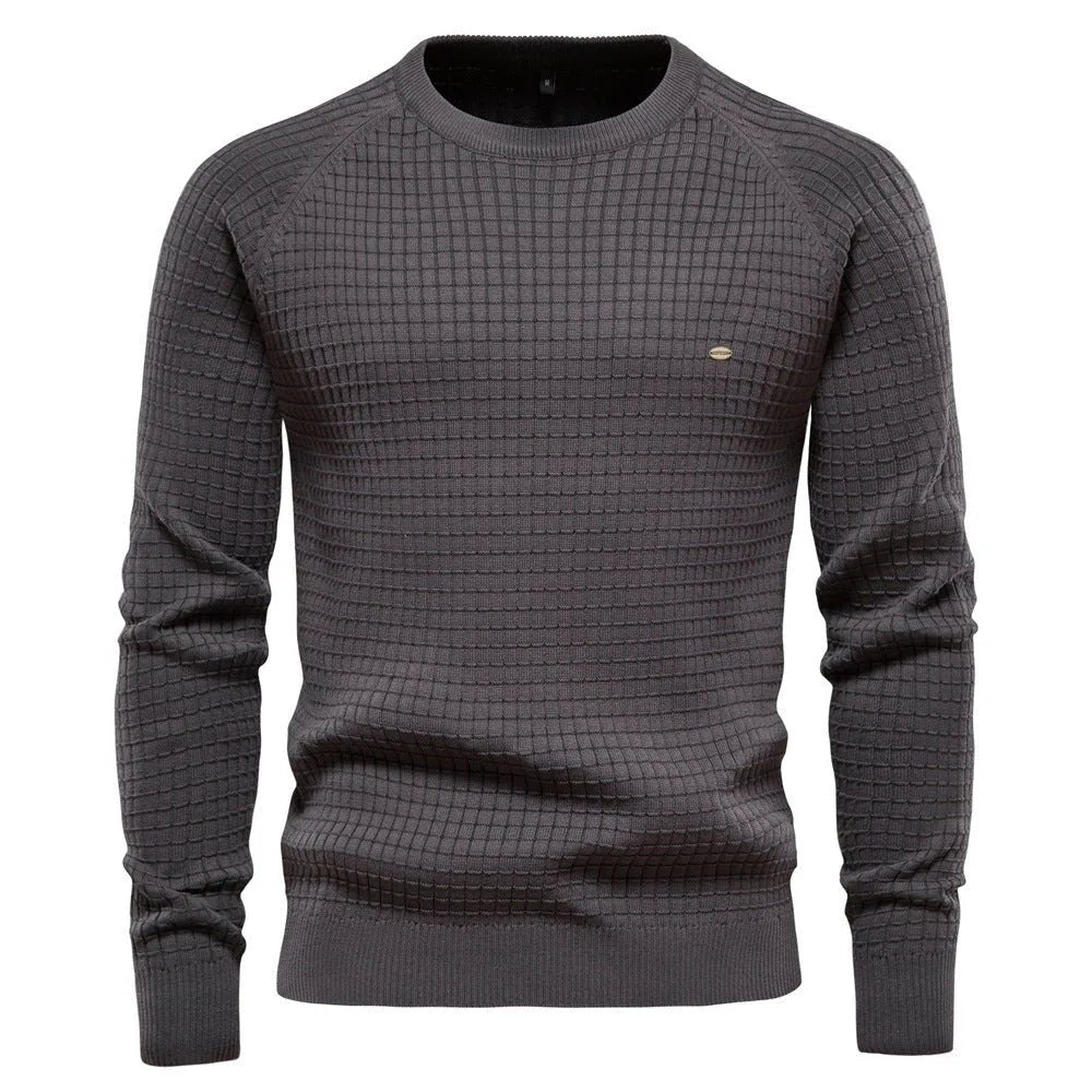 Dark grey waffle-textured knit jumper with ribbed crew neckline, shown on a male model from the front