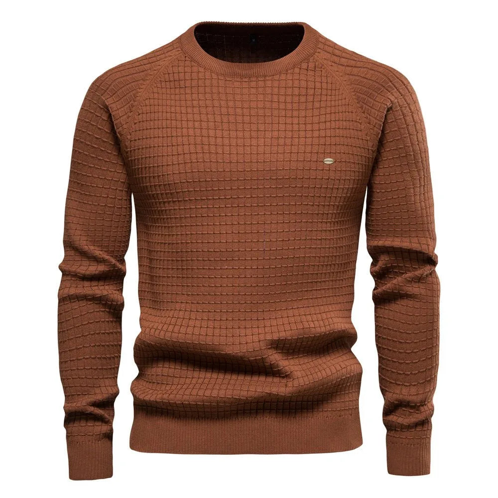 Rust brown textured knit jumper with long sleeves and ribbed cuffs, front view on a male model
