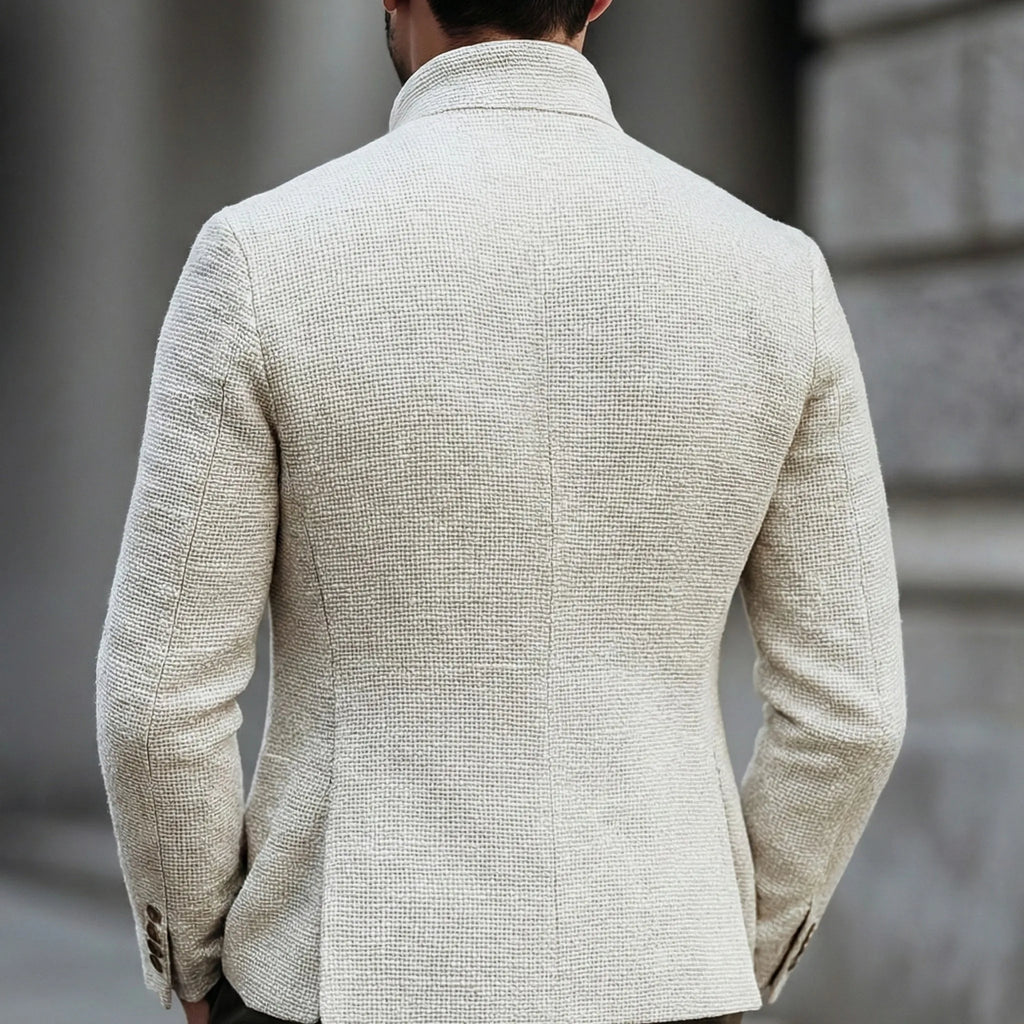 Back view of the white textured jacket showing the stand collar and tailored silhouette across the shoulders