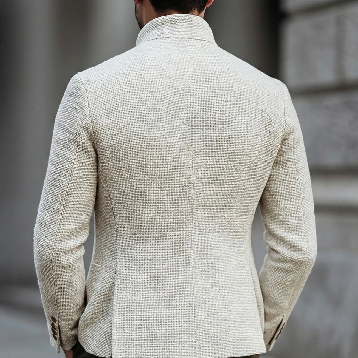 Back view of the white textured jacket showing the stand collar and tailored silhouette across the shoulders