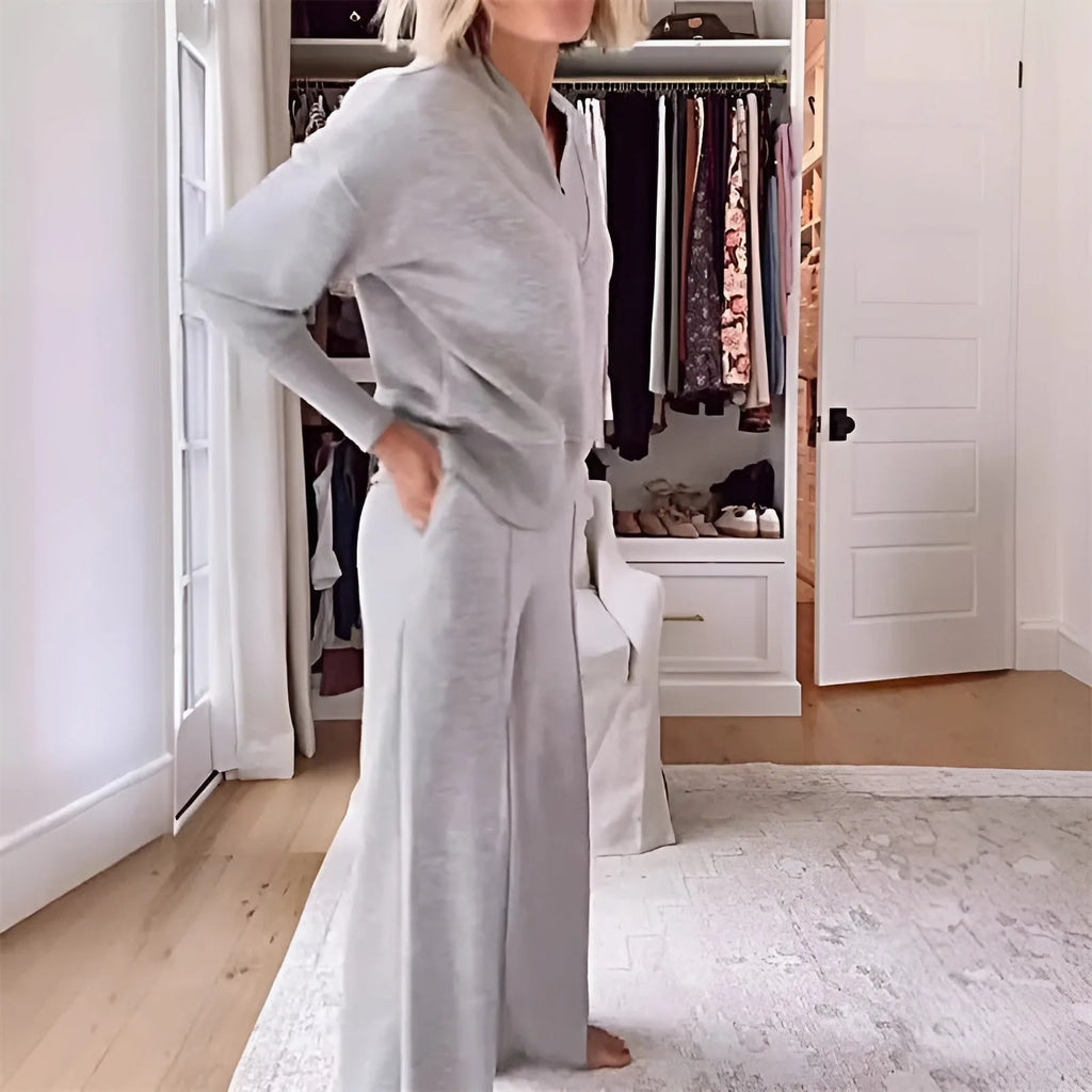 Side profile of the grey loungewear set showing the wide-leg trouser drape and relaxed jumper silhouette