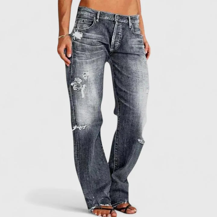 Front view of grey washed wide-leg denim jeans with distressed rips across the thigh