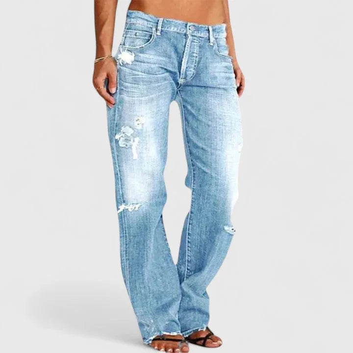 Side profile of light blue faded denim jeans showing the loose straight-leg silhouette