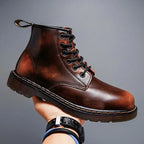 Side profile of an ember brown leather lace-up boot with ombre finish, held up against a plain grey backdrop