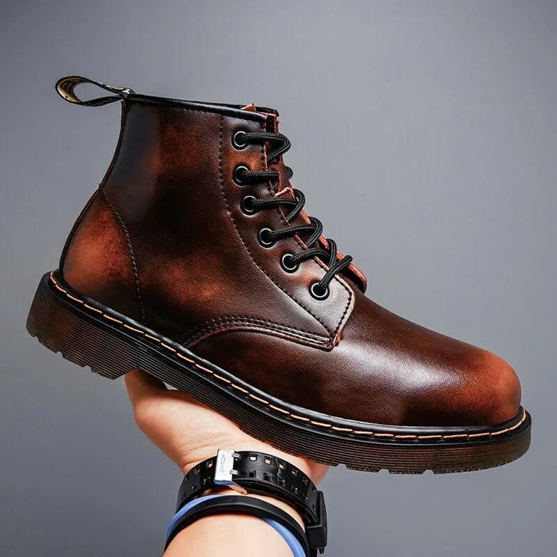 Side profile of an ember brown leather lace-up boot with ombre finish, held up against a plain grey backdrop