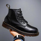 Charcoal black leather lace-up boot photographed from the side against a neutral grey background