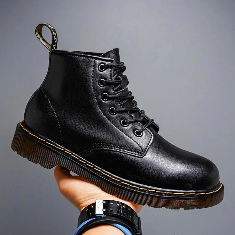 Charcoal black leather lace-up boot photographed from the side against a neutral grey background