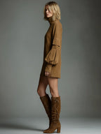 Side profile showing the relaxed silhouette, balloon sleeve pocket and asymmetric mini hemline in tan suede