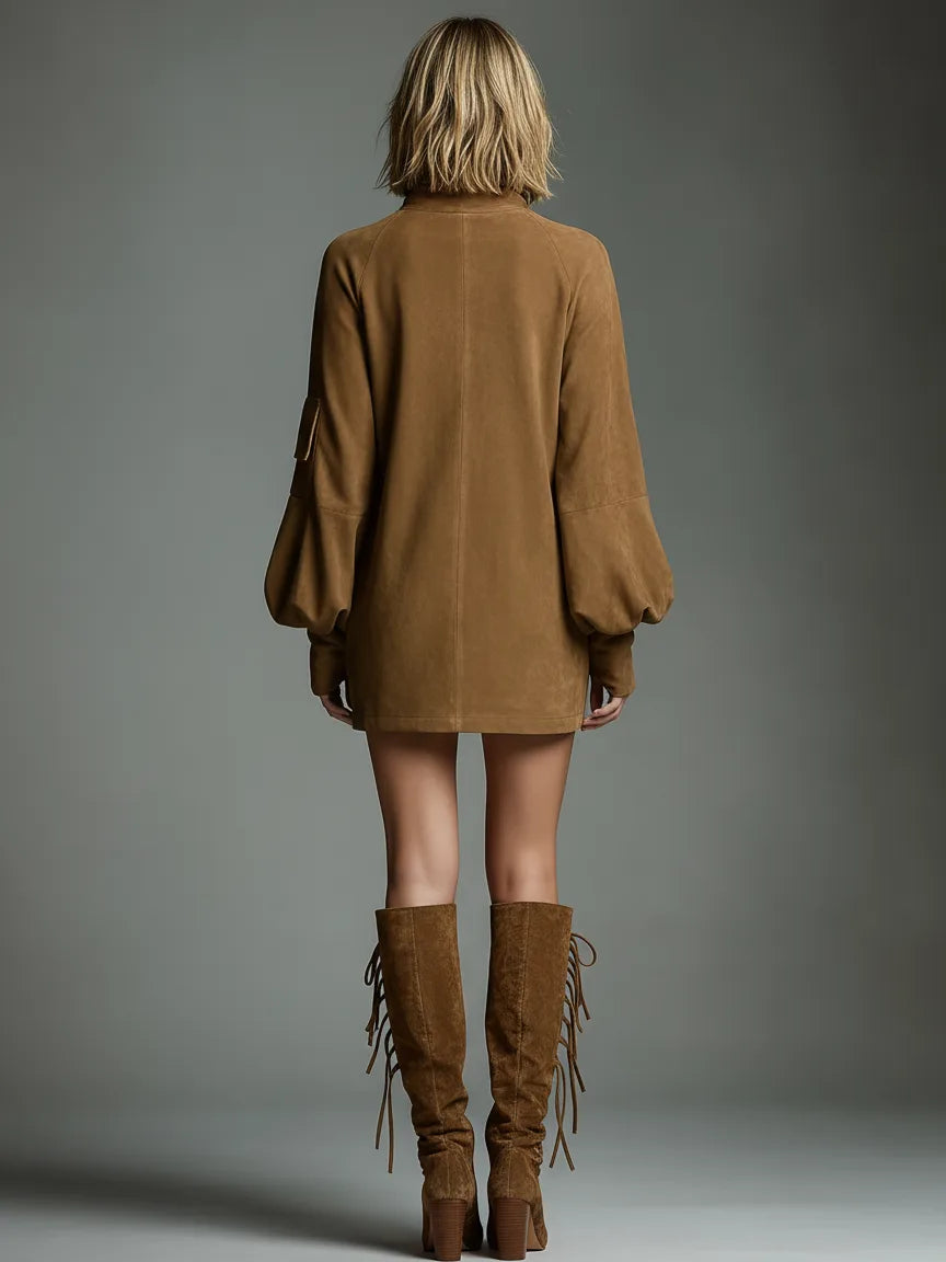 Back view of the tan suede mini dress showing the centre seam, raglan sleeves and lace-up suede boots