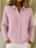 Pink waffle-knit collared cardigan shown open-necked with white buttons, styled with a layered chain necklace.