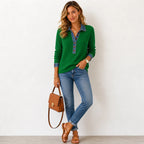 Front view of a green ribbed knit henley jumper with denim trim collar and button placket, styled with jeans and a tan handbag