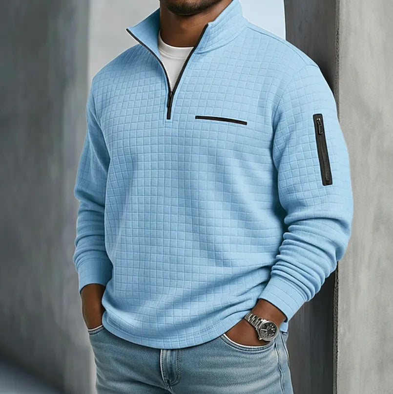Front view of a sky blue waffle-knit quarter-zip pullover worn over a white t-shirt with jeans