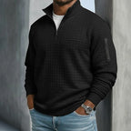 Side angle of a quarter-zip waffle jumper highlighting the textured fabric and sleeve zip pocket detail