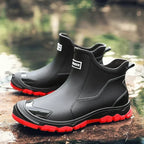 Black and red chelsea rain boots with contrasting red tread sole and toe guard