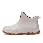 Side profile of a beige rubber chelsea boot showing tan sole on a plain white background