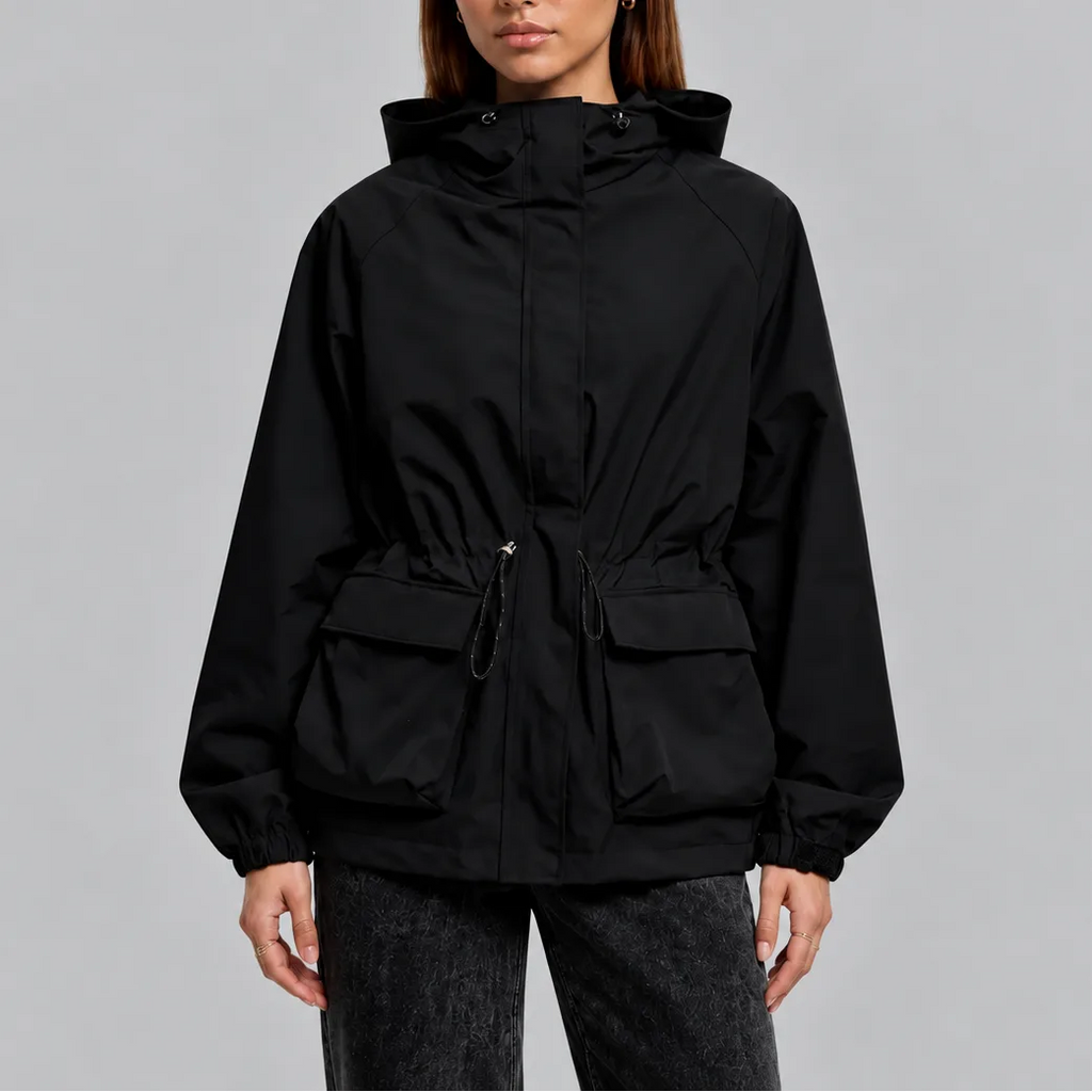 Front view of a woman wearing a black hooded waterproof jacket with zip fastening and flap pockets
