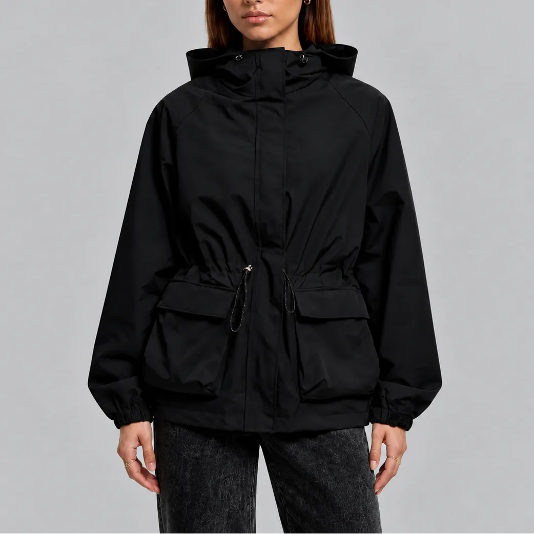 Front view of a woman wearing a black hooded waterproof jacket with zip fastening and flap pockets