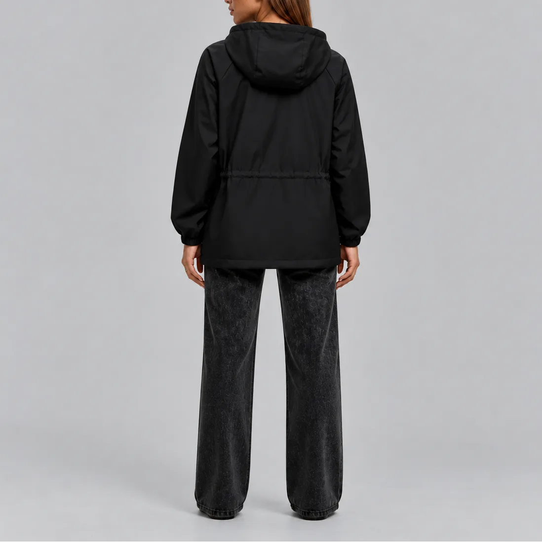 Back view of the black hooded jacket showing the drawstring waist and elasticated cuffs
