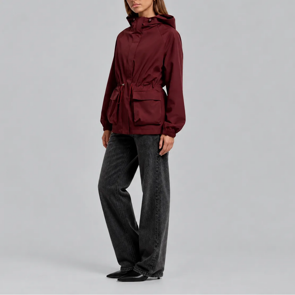 Side profile view of the burgundy jacket worn with wide-leg jeans and ankle boots